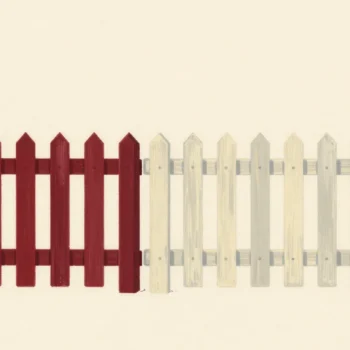 Two picket fence sections meeting at one shared post, one painted vermilion, one cream, with no gap between them.