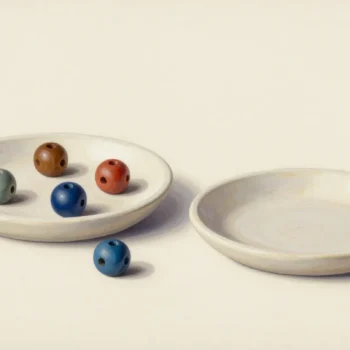 Colored ceramic beads in a pale shallow tray beside an empty tray and a separate blue bead.