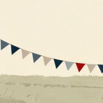A long string of bunting laid out on a village green while two hands check the last knot