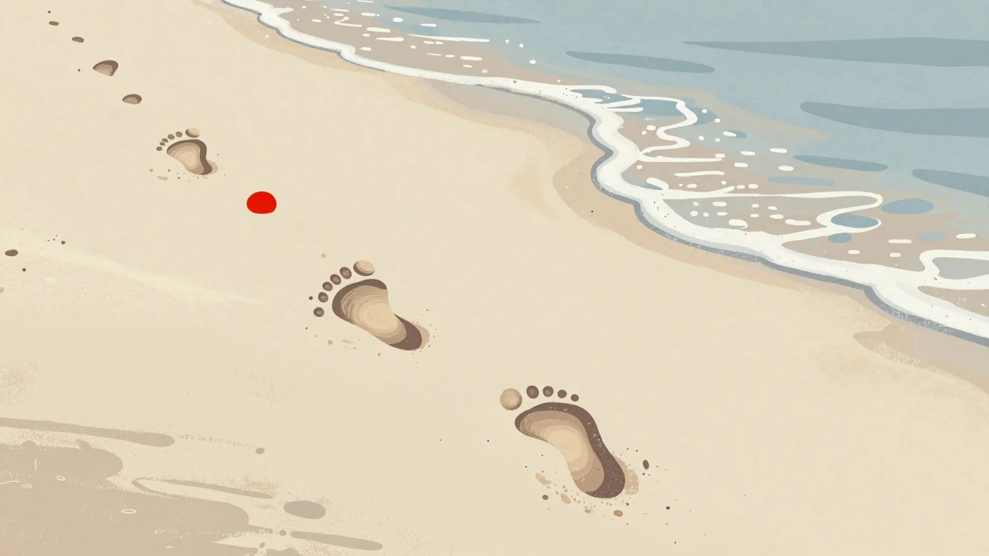 Footprints along a wet shoreline, crisp in front and fading further back as a wave smooths the oldest away.