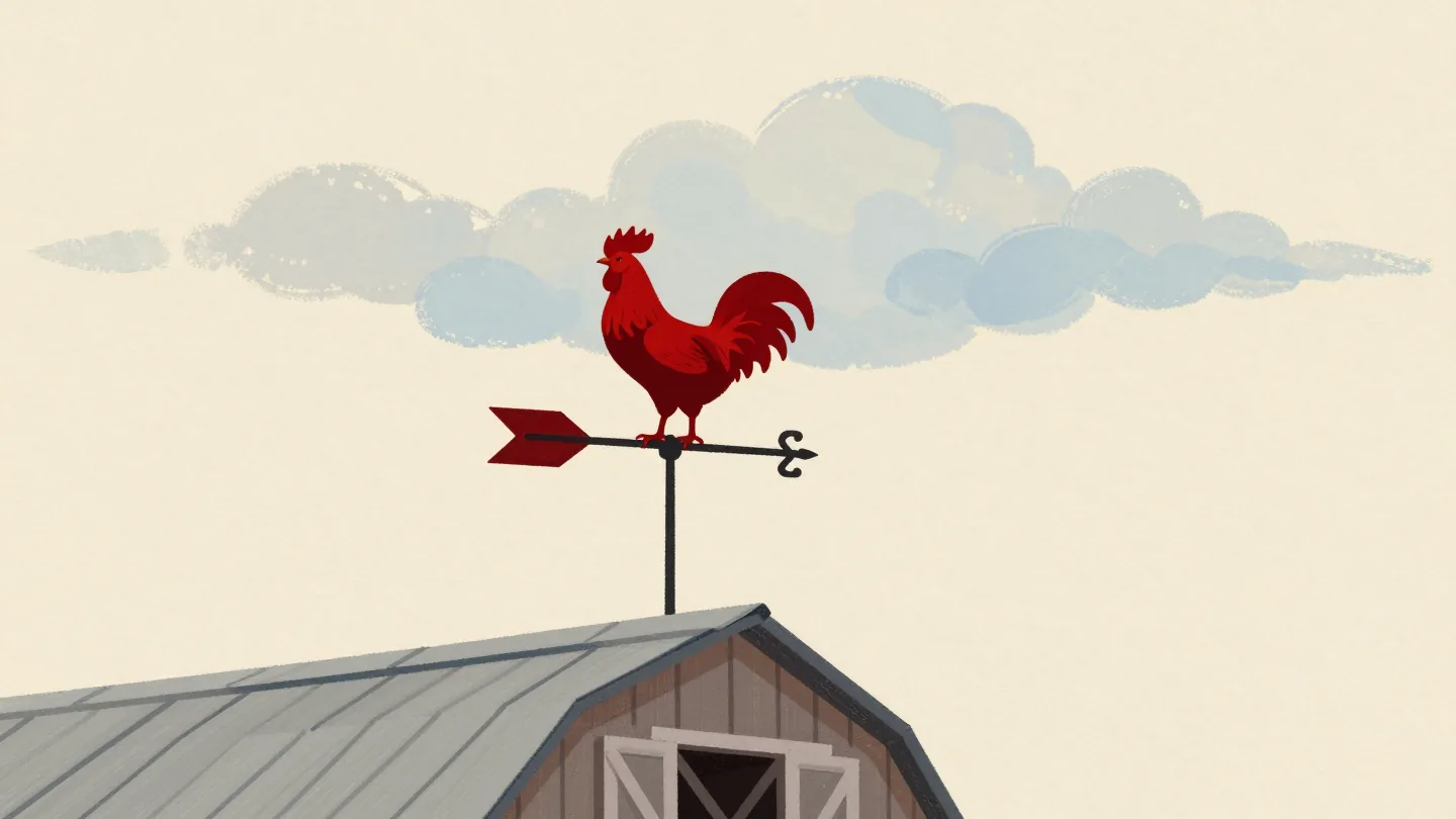 A weather vane with a red rooster turning with the wind on a barn roof