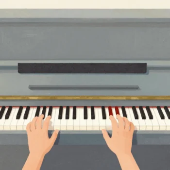 A piano with felt covering the outer keys so only the middle keys can be played, two hands resting on them.