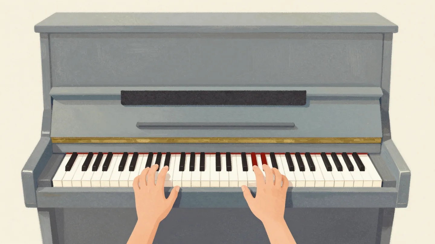 A piano with felt covering the outer keys so only the middle keys can be played, two hands resting on them.