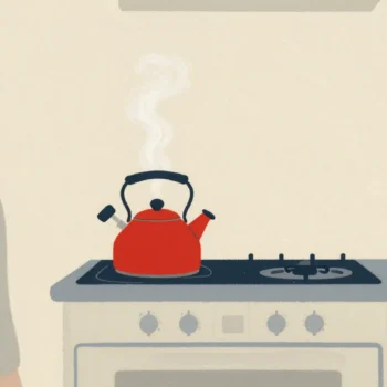 A red kettle whistling on the stove while someone in the next room turns to it