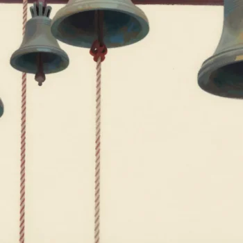 Bell ropes in a tower ringing chamber, most tied up out of reach, one hand gripping the single free rope.