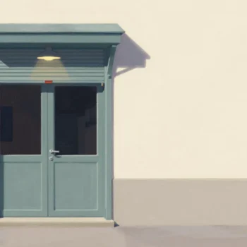 A shop door at dusk with the shutter half down and a blank red board hanging beside it