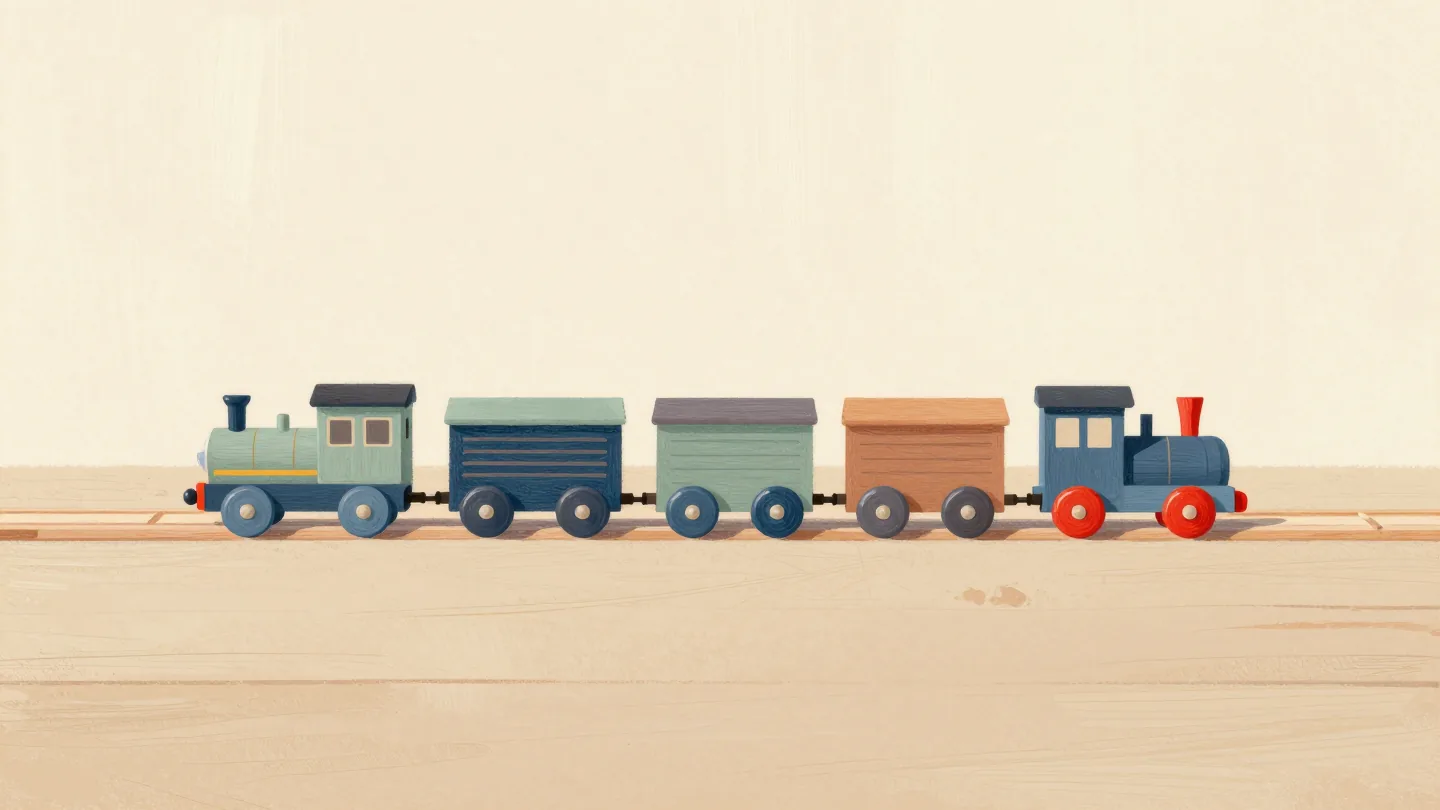 A wooden toy train with its colored carriages uncoupled and laid in a straight line on the floor, engine at the front.