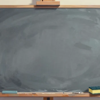A slate board on an easel, partly wiped clean, with a sponge resting on the ledge.