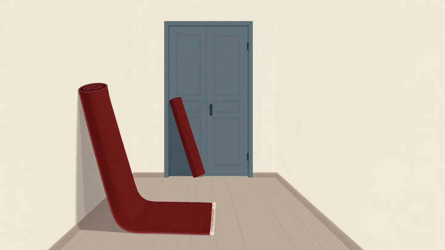 A cleared hallway with rugs rolled up against the wall and a wardrobe just brought in.