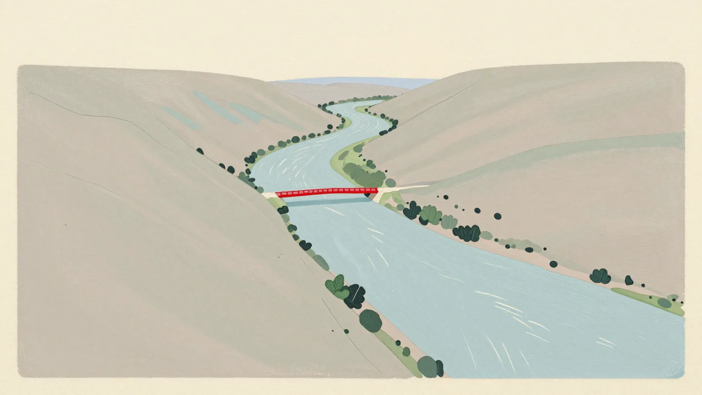 Small streams joining larger rivers that merge into one wide river, a red bridge across it.