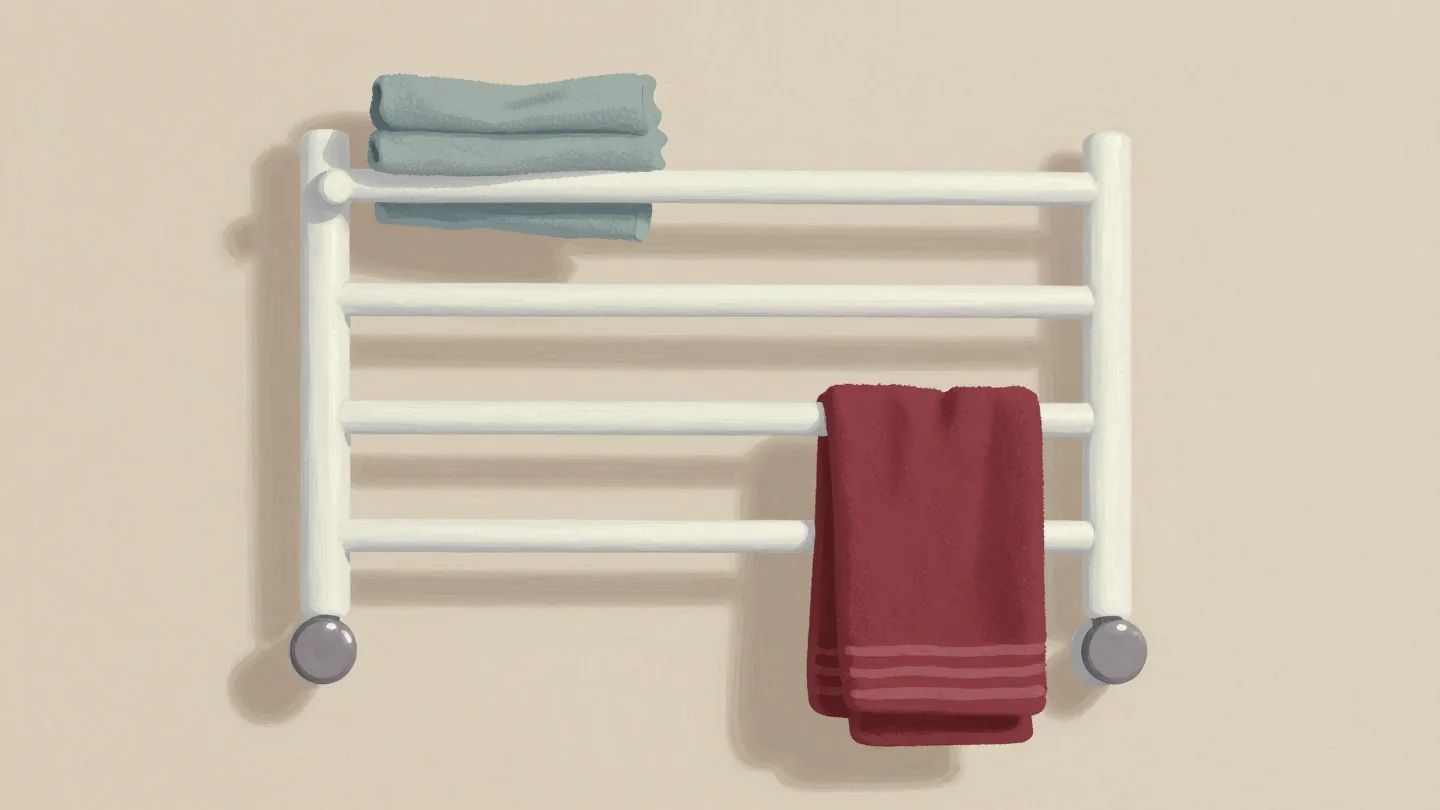 A swing-arm towel rail with some arms swung out holding towels and others folded flat, one red towel.