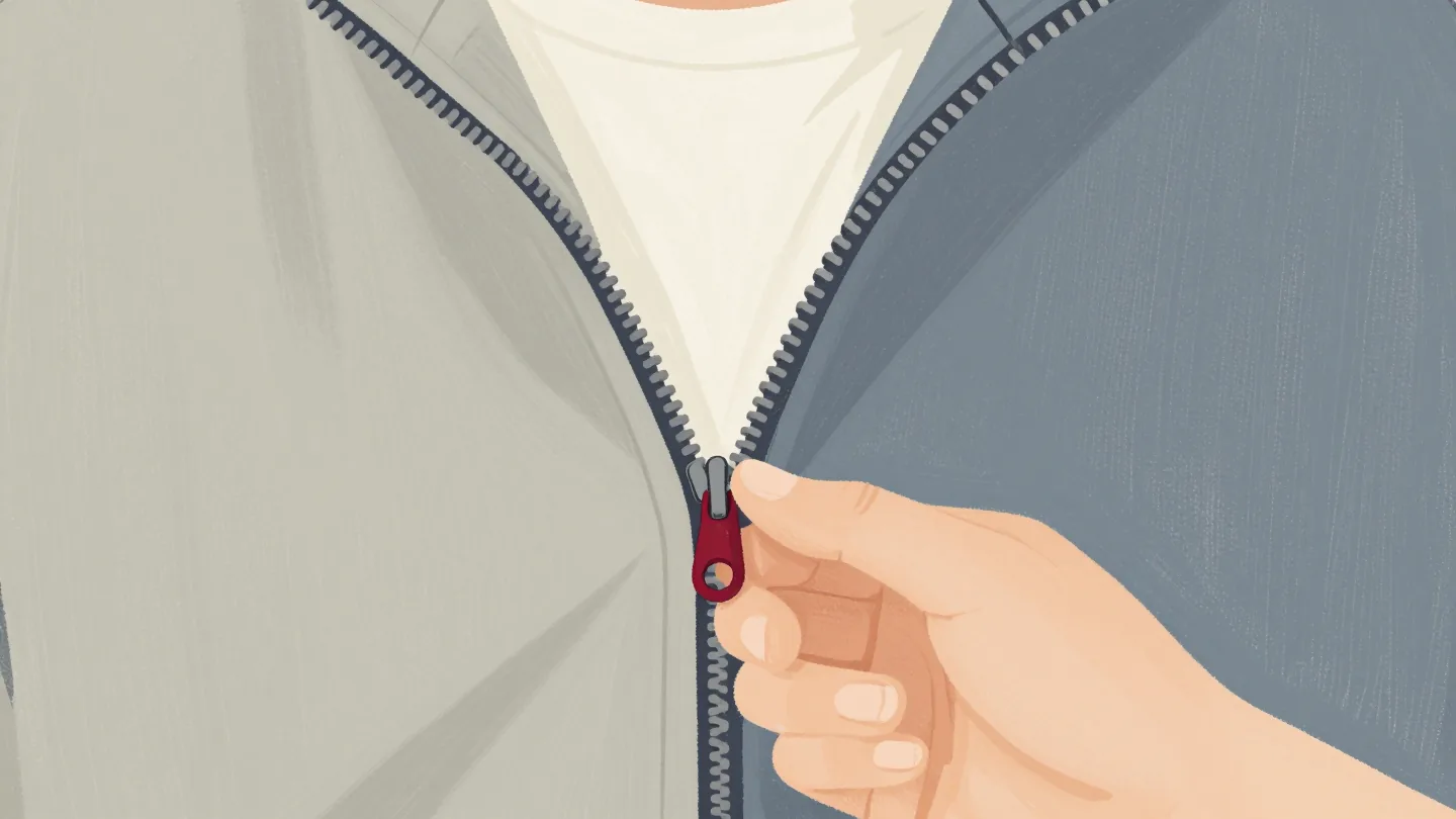 A hand trying to close a zip whose two sides do not match, the red pull stuck.