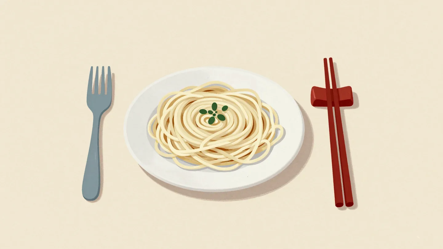 A fork and chopsticks resting side by side beside a plate of noodles