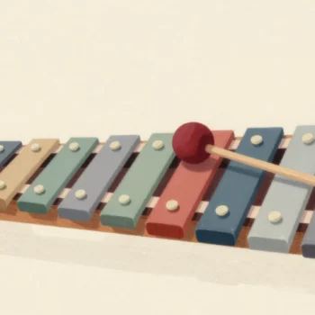 A wooden xylophone with bars stepping from long to short, a red mallet resting between two neighbouring bars.