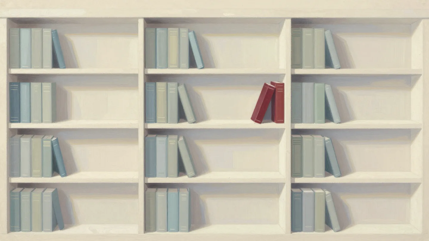A bookcase with every shelf about two-thirds full, leaving space for new books, one being slipped into a gap.