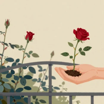 A hand passing a cut rose stem with one spotted leaf and a pouch of soil across a garden gate