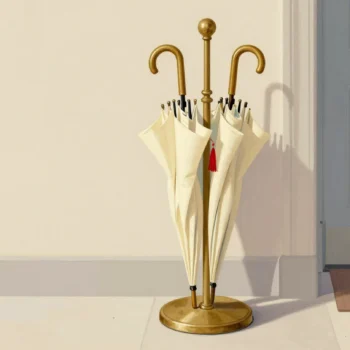 A brass umbrella stand of identical cream umbrellas, one marked only by a small red tassel.