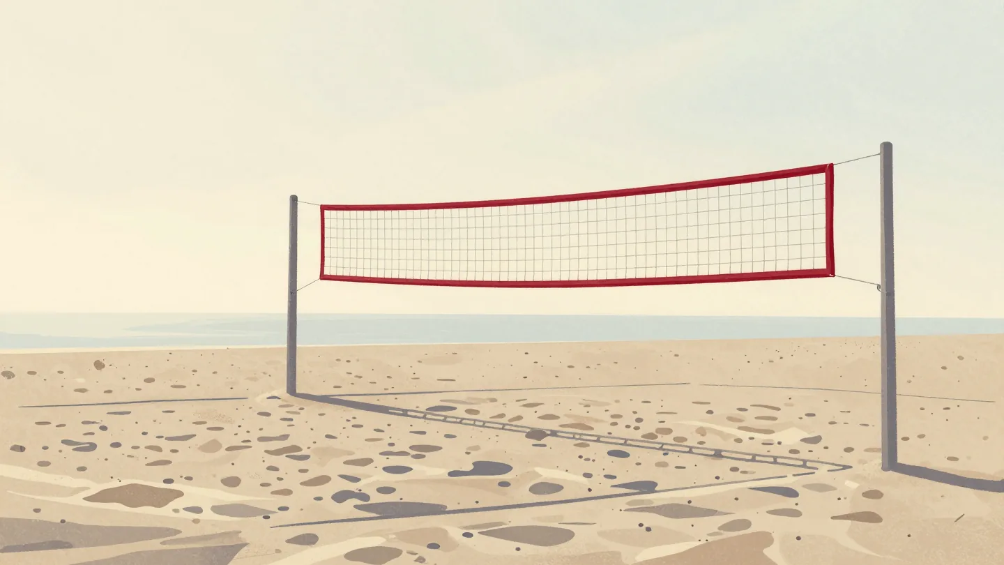 A beach volleyball net standing intact on smooth sand at dawn, every footprint around it washed away by the tide.