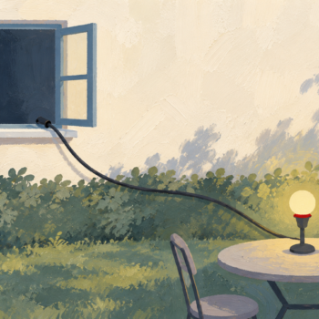 An outdoor lamp remains connected to a remote source through an extension cable