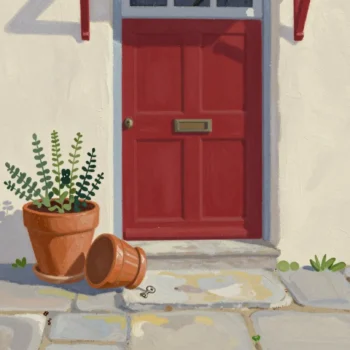 A flowerpot tipped back beside a cottage front door, showing a spare house key hidden underneath.