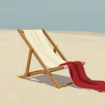 Two beach towels thrown onto one empty deckchair at once, a cream towel covering the seat and a red one sliding off.