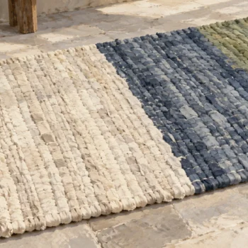 A rag rug with broad repeated-color bands and distinct color transitions