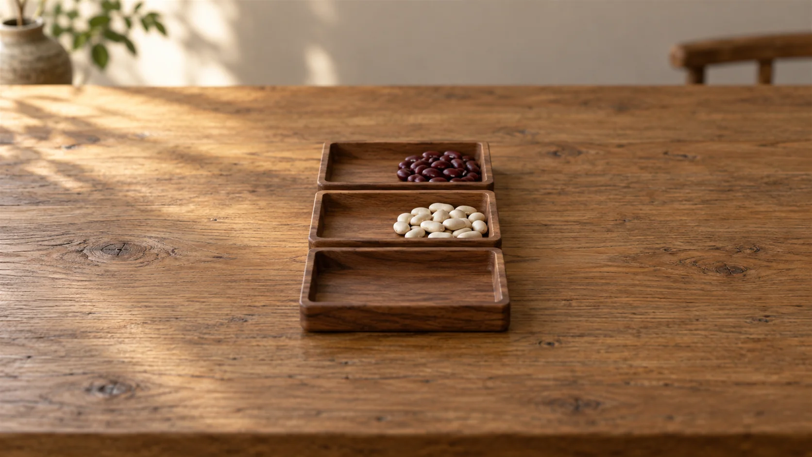 Small wooden trays arranged in a compact sequence with beans sorted into separate groups.