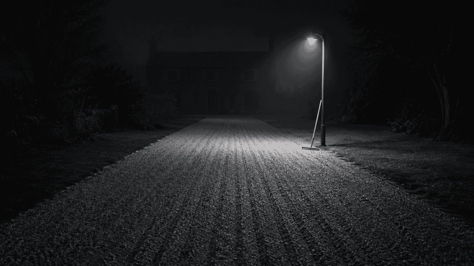 Gravel path illuminated at night.