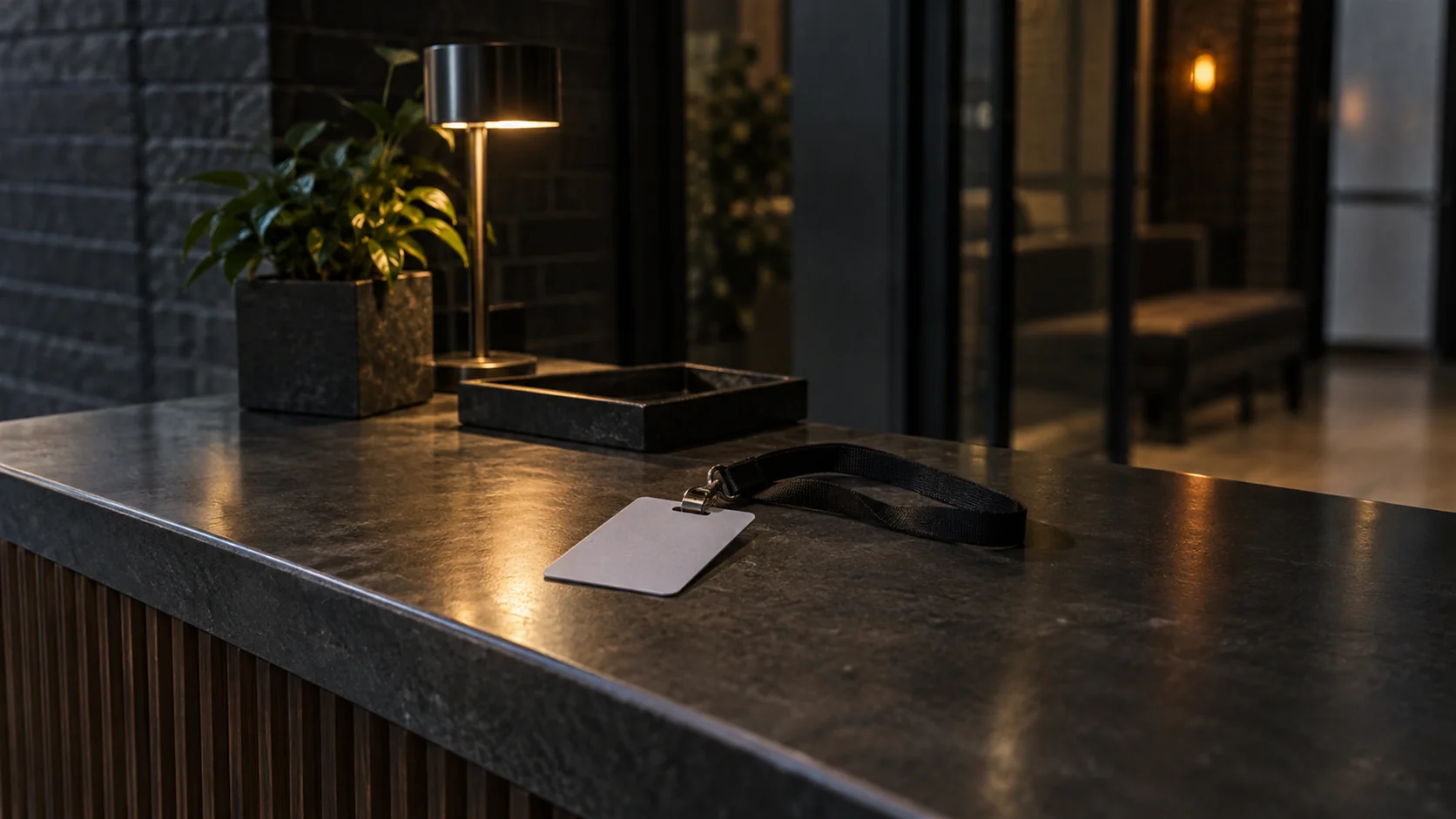 A blank visitor badge lying face down on an empty reception counter.