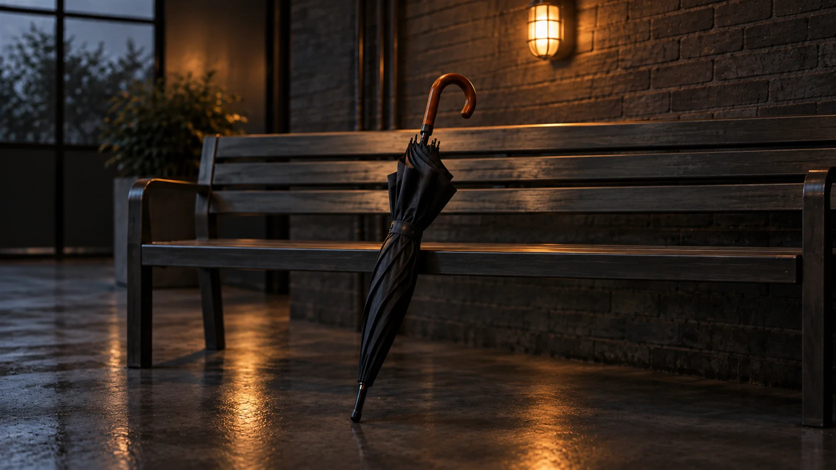 A waiting room bench with one forgotten umbrella leaning against it, the room otherwise empty.