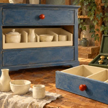 Original vessels and supporting fittings remain preserved beside a replacement drawer.