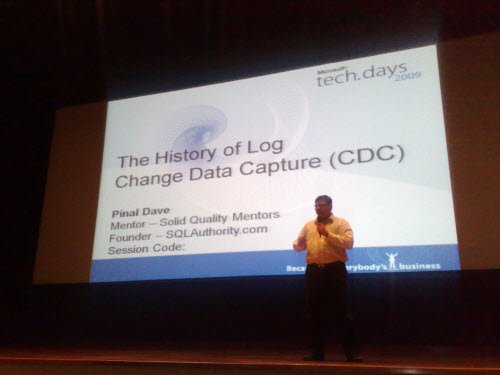 Man standing beside a presentation screen about 'Locking Concepts.