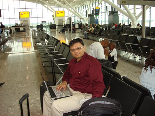 Man using laptop at airport.
