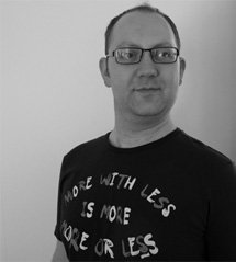 A man in a black shirt with motivational text.