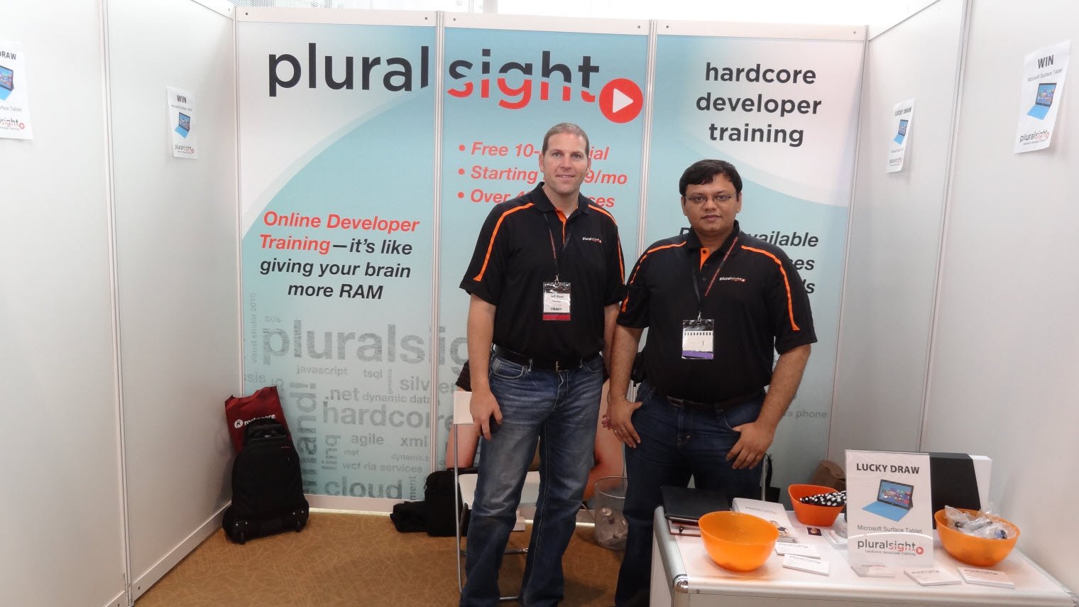Two people standing together in front of a display at the conference