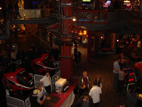 A group of people in a gaming arcade.