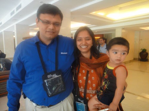 A man and woman with a child posing for a photo.