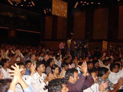 Conference attendees applauding.