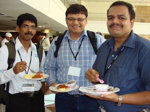 Jacob (XML), Pinal (SQL), Vikram (Silverlight) Three men with badges, holding plates of food.