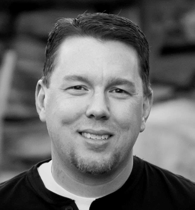 A man smiles at the camera.