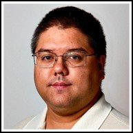 A person with glasses and a white shirt.