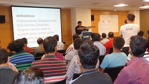 A SQL Server training session with attendees facing the presenter