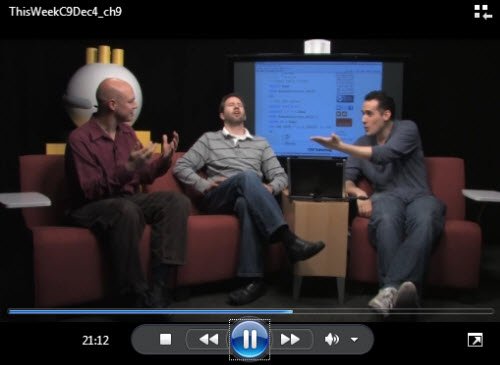 Three men discussing SQL Server query results.