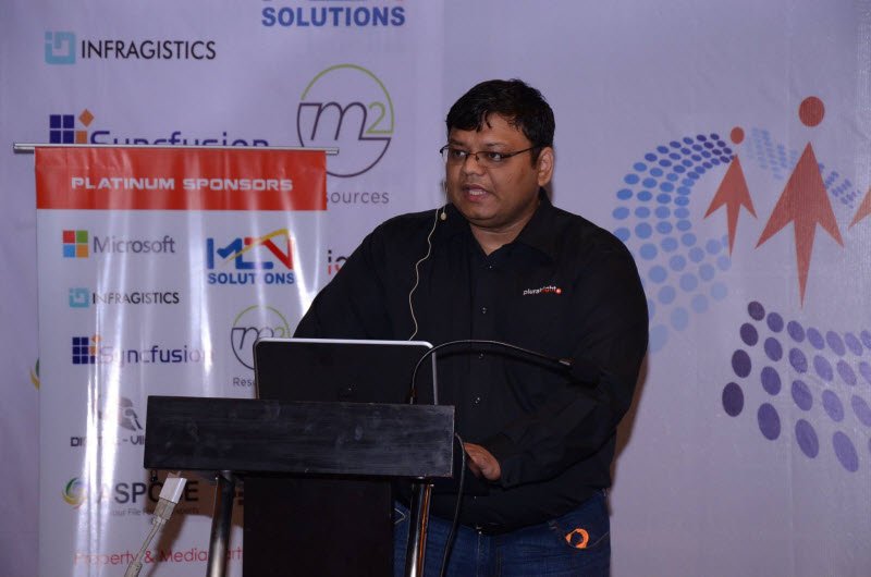 Conference presenter at podium.