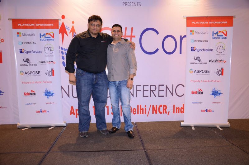 Two men standing at a conference.