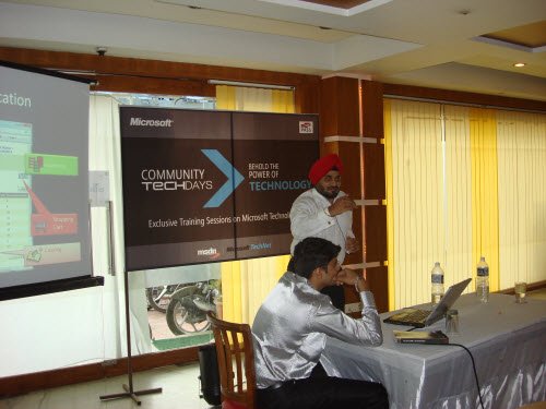 Two men discussing in a Microsoft Training session.