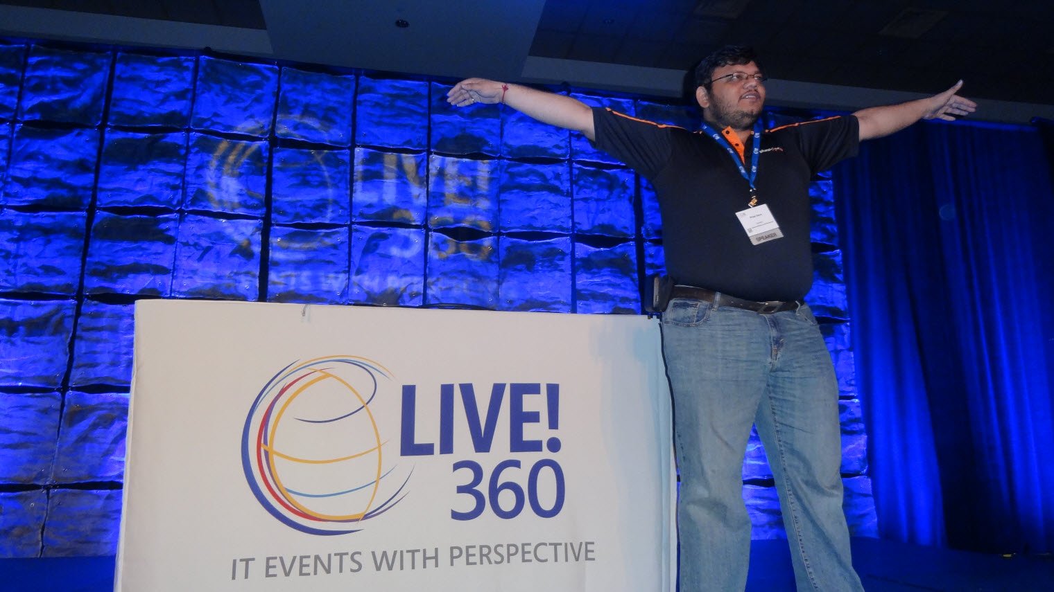 SQLLive 360 event sign and person posing.