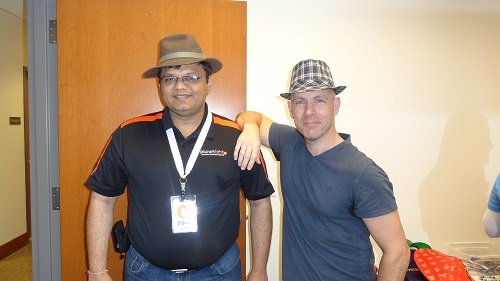 Two men with hats at a professional event.