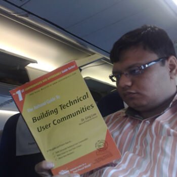 A man reading a book on a train.