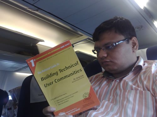 A man reading a book on a train.